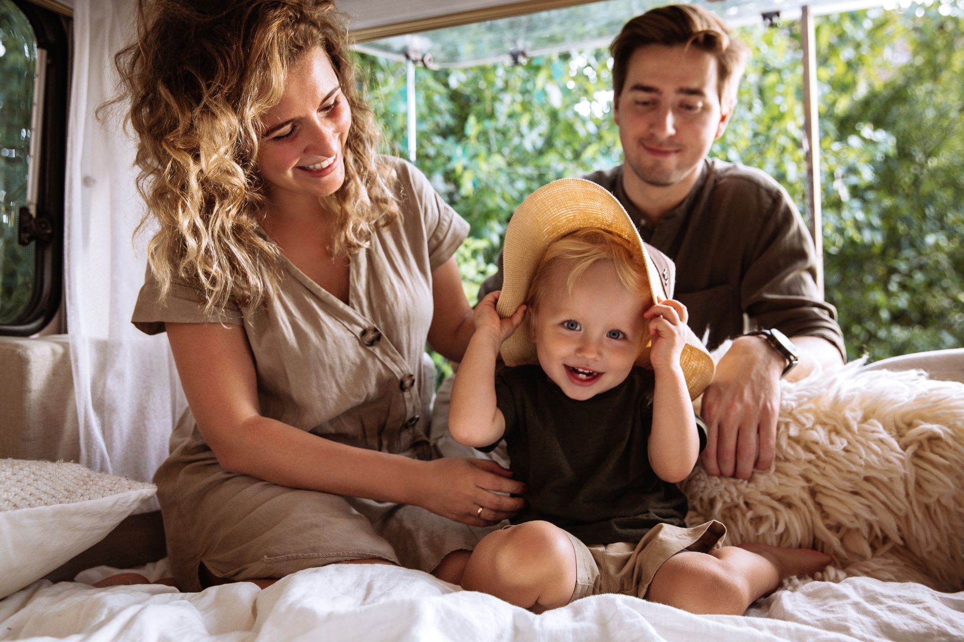 Loving parents enjoy spending time with little kid boy travelling together on camper rv